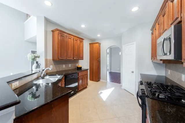 a kitchen with a stove a sink and a refrigerator