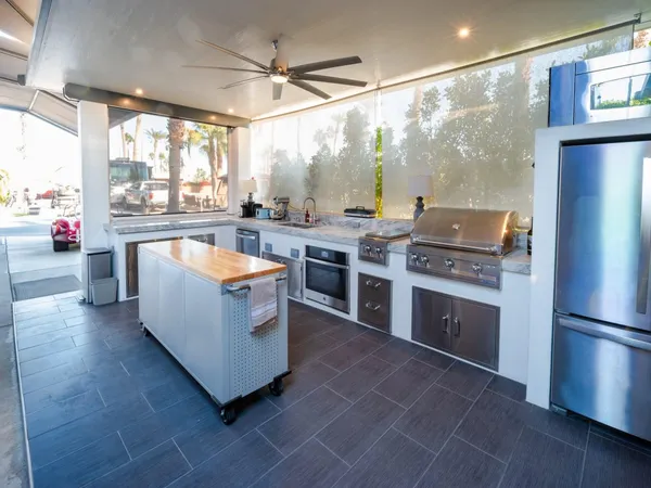 a large kitchen with stainless steel appliances granite countertop a stove and a refrigerator