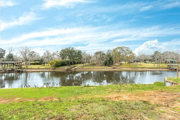 a view of a lake with houses in the back