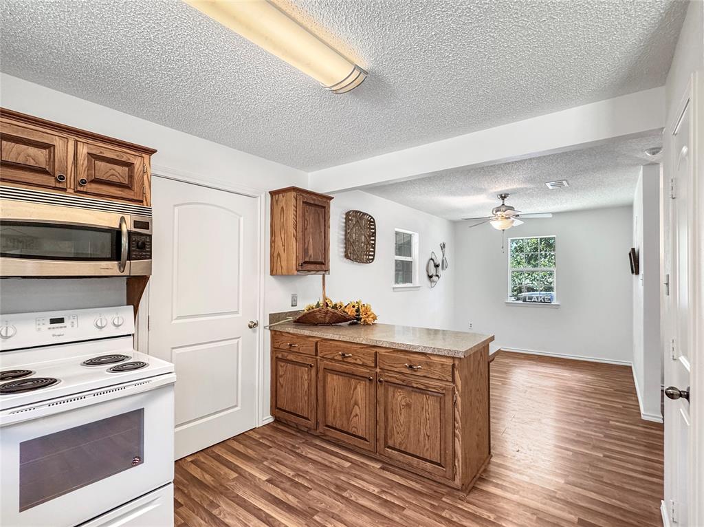 1005 Wood Canyon Road Tool, TX 75143 - Photo 13 of 26 a kitchen with a stove and a microwave
