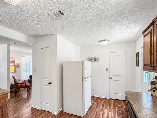 a view of a livingroom with wooden floor and a flat screen tv