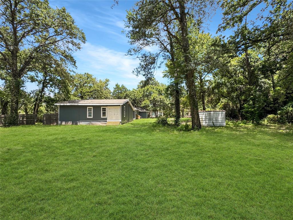 1005 Wood Canyon Road Tool, TX 75143 - Photo 25 of 26 a view of a house with a yard