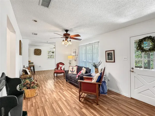 a living room with furniture and a wooden floor