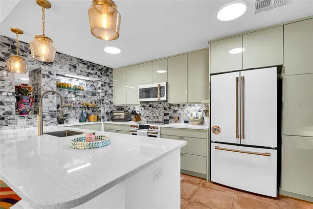 a kitchen with refrigerator and cabinets