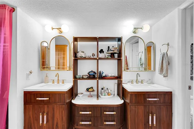 a bathroom with a double vanity sink and a mirror