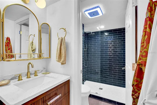 a bathroom with a sink a vanity and a mirror