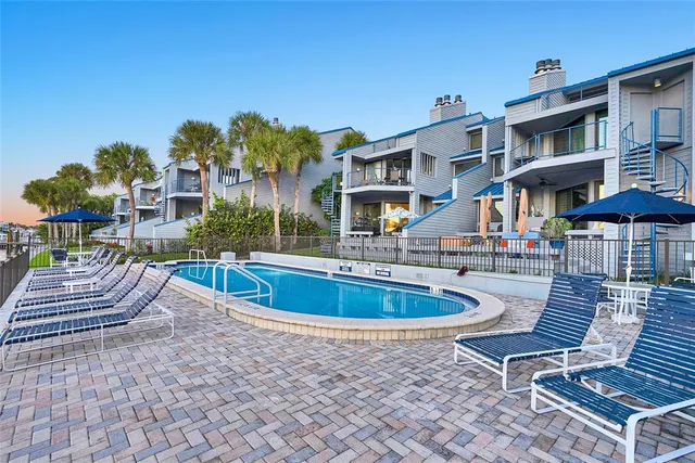 a front view of a residential apartment building with a yard and balcony