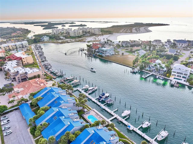 an aerial view of ocean and residential building with outdoor space