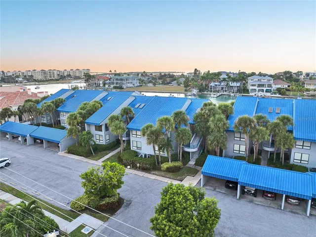 an aerial view of residential houses with outdoor space and ocean view