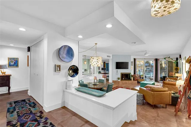 a living room with fireplace furniture and a large window