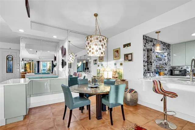 a dining room with furniture a chandelier and wooden floor