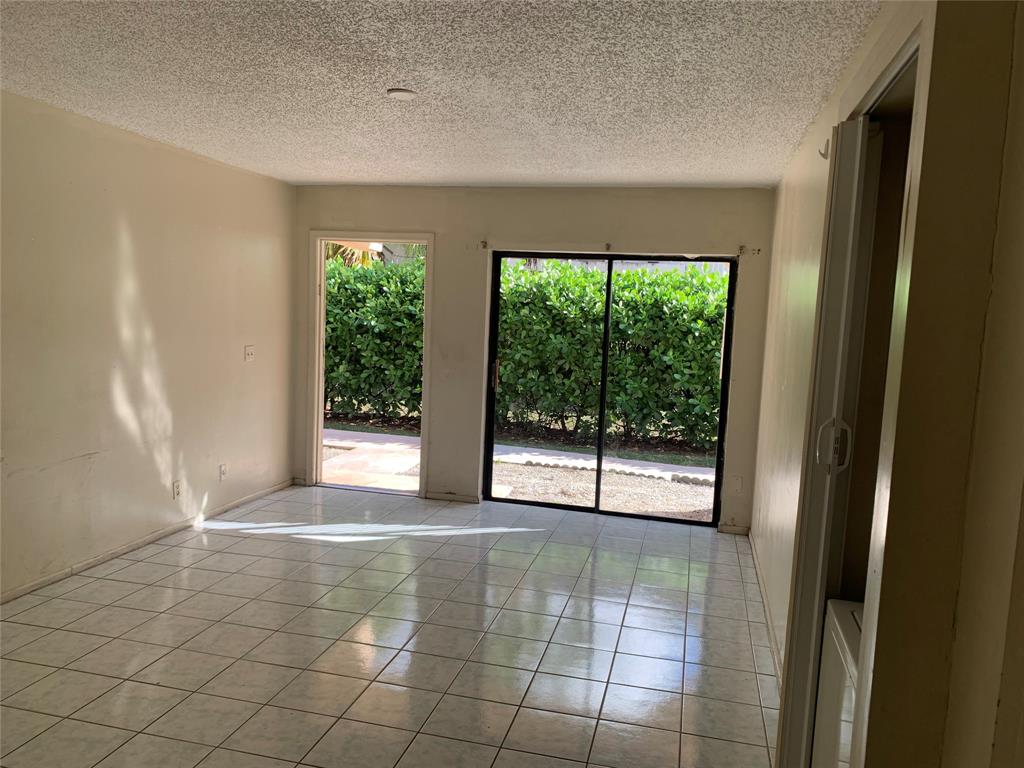 10850 Royal Palm Boulevard, Unit 10850 Coral Springs, FL 33065 - Photo 3 of 8 a view of an empty room with a window
