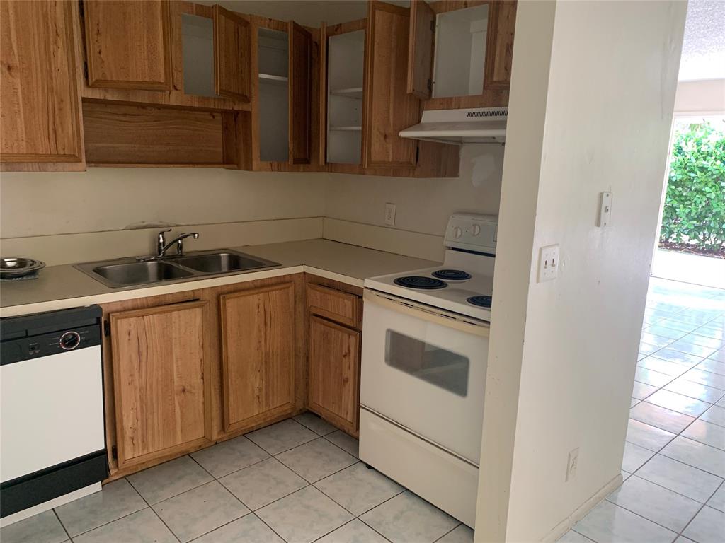 10850 Royal Palm Boulevard, Unit 10850 Coral Springs, FL 33065 - Photo 5 of 8 a kitchen with a sink and cabinets