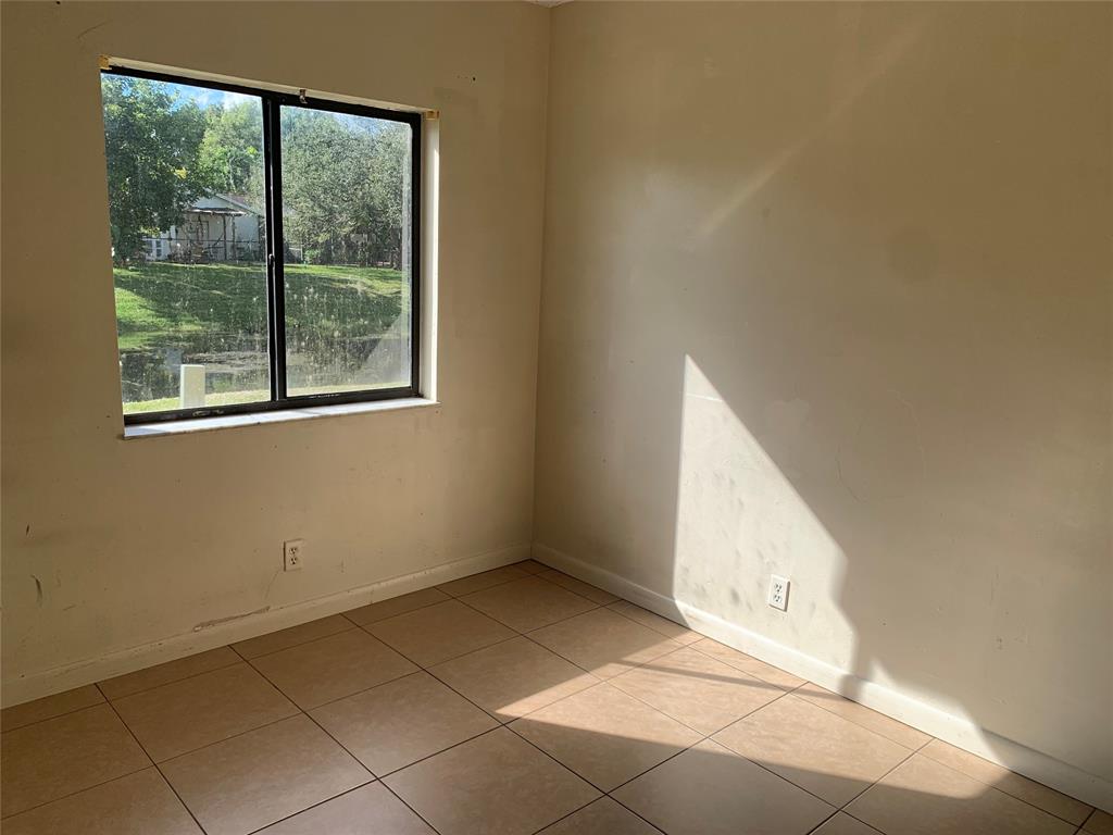 10850 Royal Palm Boulevard, Unit 10850 Coral Springs, FL 33065 - Photo 6 of 8 an empty room with windows