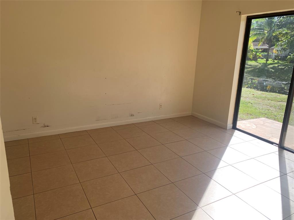 10850 Royal Palm Boulevard, Unit 10850 Coral Springs, FL 33065 - Photo 8 of 8 a view of an empty room and window