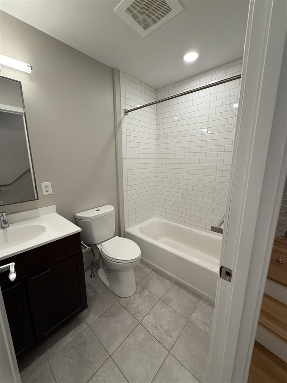 6 Chatham Street, Unit 308 Worcester, MA 01609 - Photo 8 of 10 a bathroom with a bathtub shower sink vanity and toilet