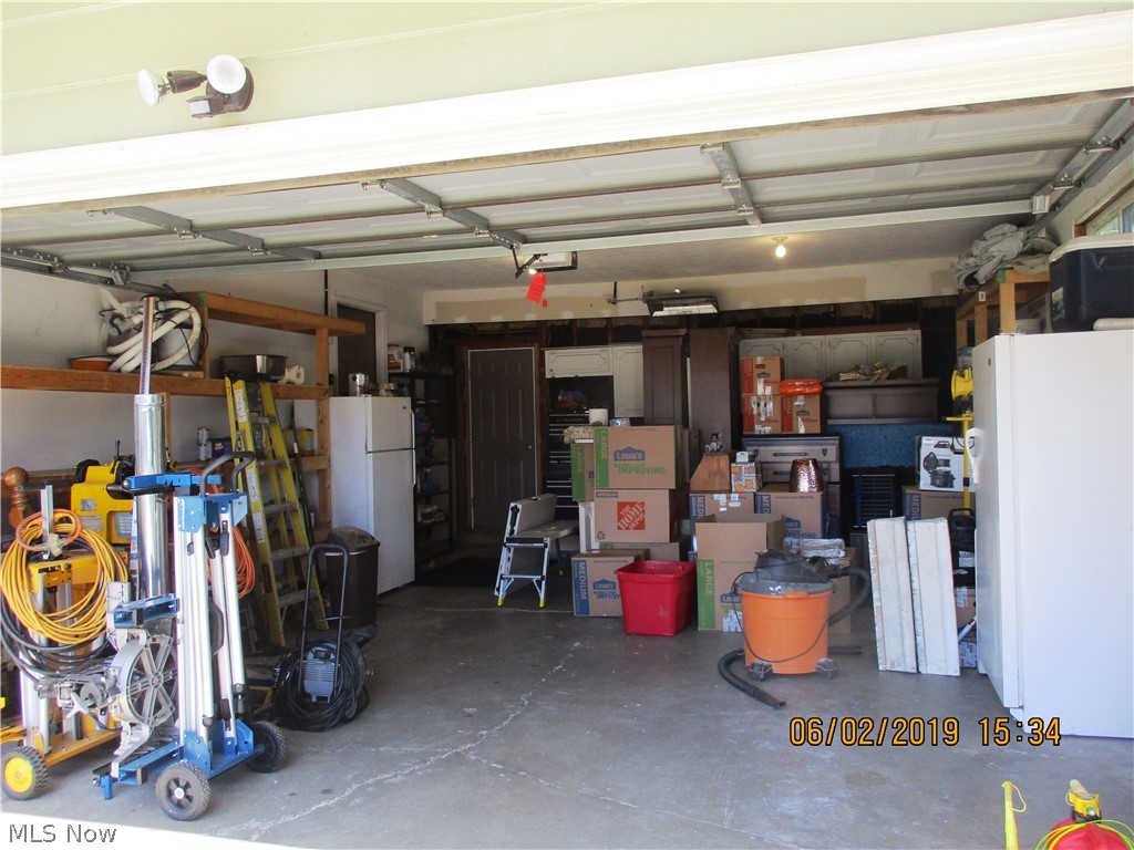 6803 Lake Road Madison, OH 44057 - Photo 5 of 25 Heated garage with shelves and cabinets