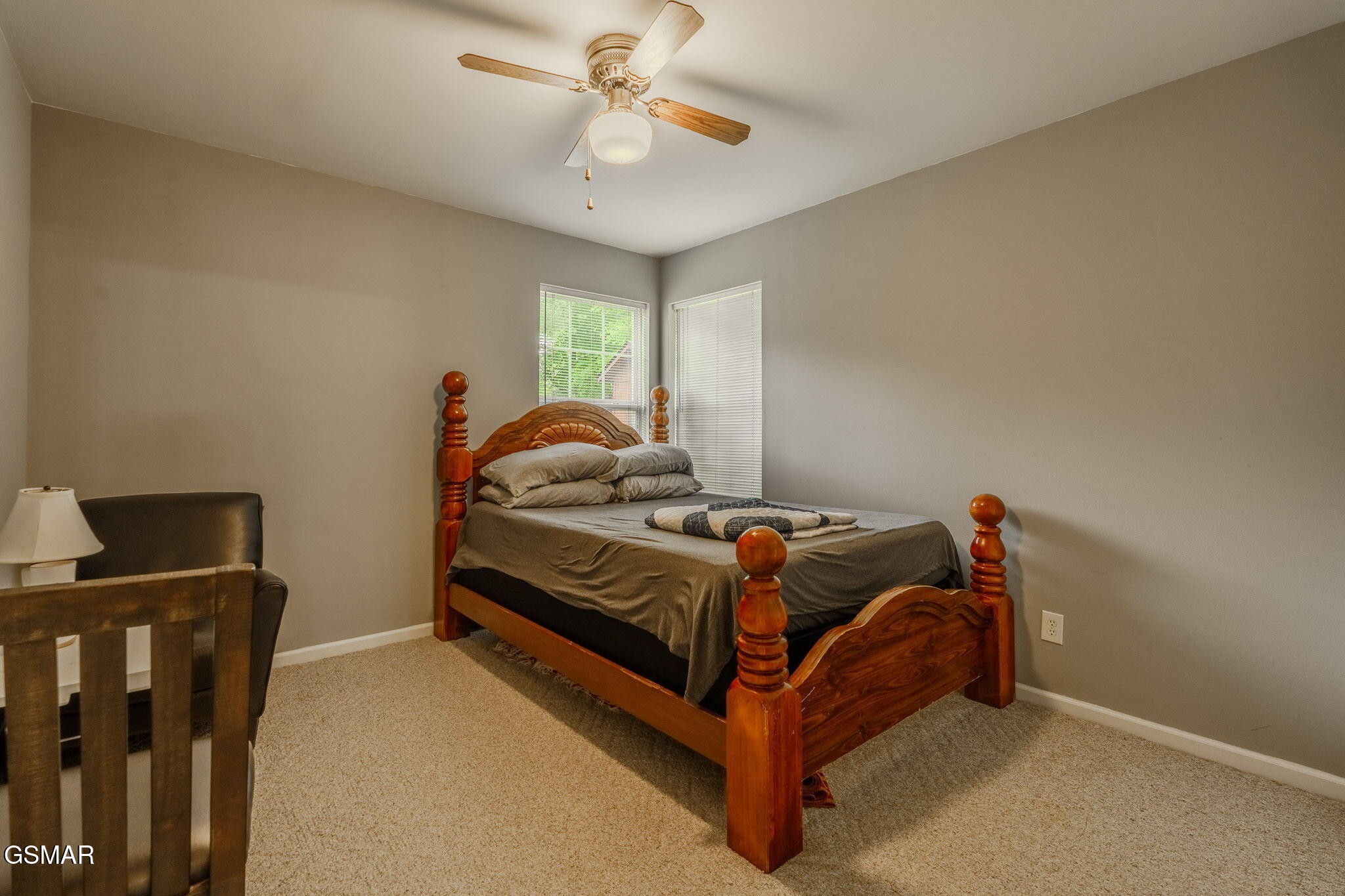 7213 Emerald Heath Road Powell, TN 37849 - Photo 18 of 27 a bedroom with a bed and a chandelier