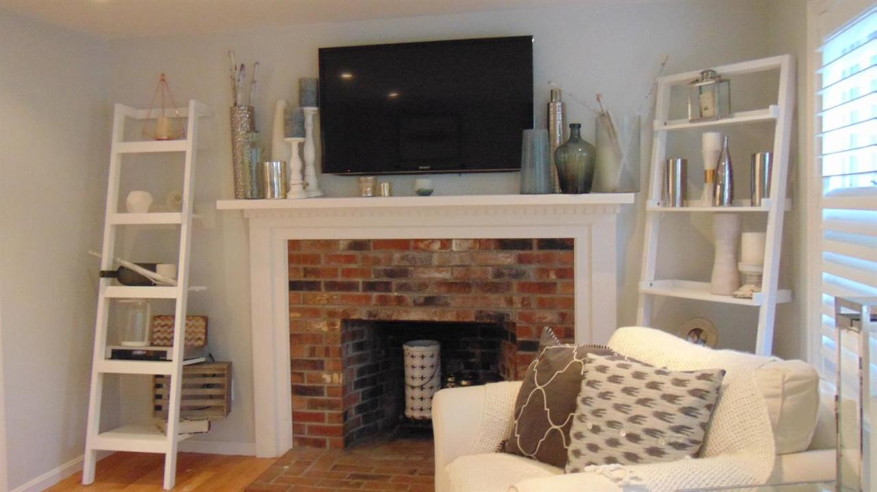 25 Mashpee Road Cotuit, MA 02635 - Photo 8 of 15 a living room with furniture and a fireplace