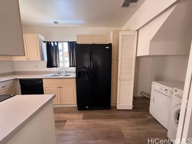 a kitchen with a refrigerator and a sink