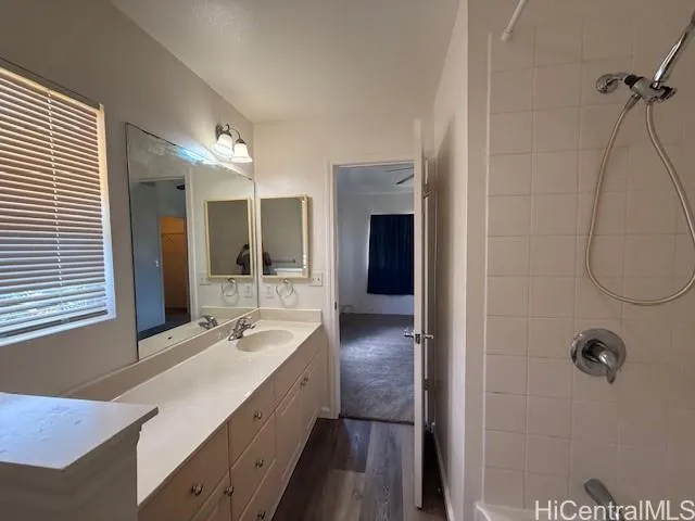 a bathroom with a double vanity sink a mirror and shower