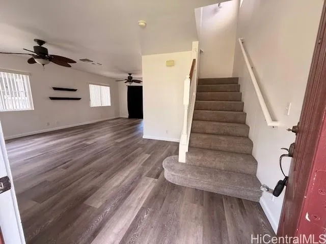a view of entryway and hall with wooden floor