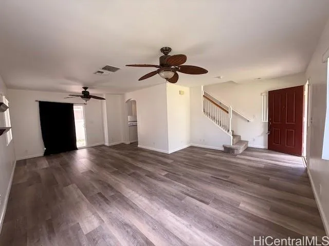 a view of an empty room and wooden floor