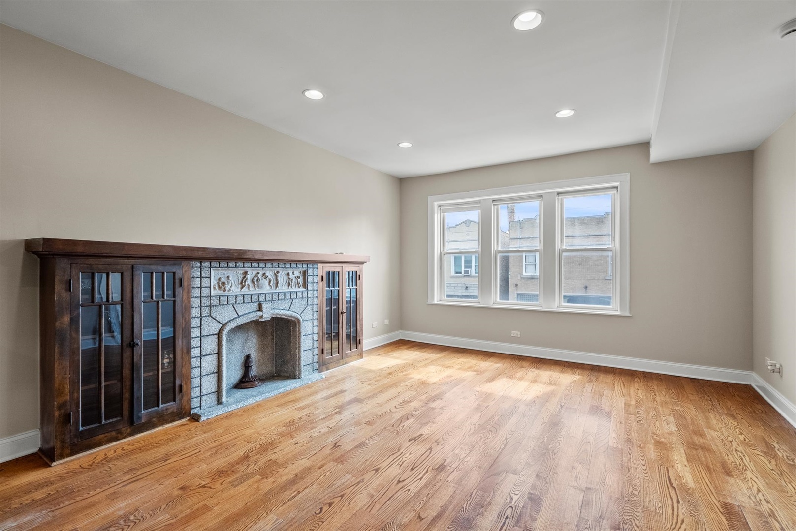 6118 West Addison Street Chicago, IL 60634 - Photo 22 of 35 wooden floor fireplace and windows in an empty room