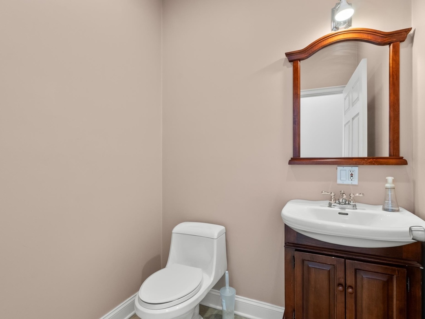6118 West Addison Street Chicago, IL 60634 - Photo 7 of 35 a bathroom with a toilet sink and mirror