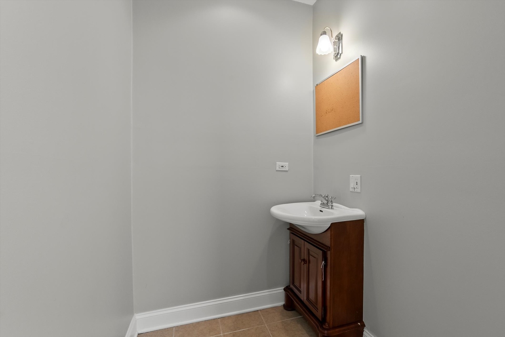 6118 West Addison Street Chicago, IL 60634 - Photo 10 of 35 a bathroom with a sink a mirror and vanity