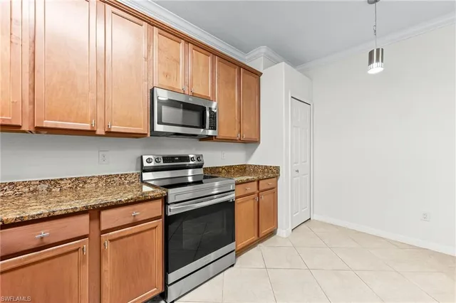 a kitchen with granite countertop cabinets stainless steel appliances and a sink