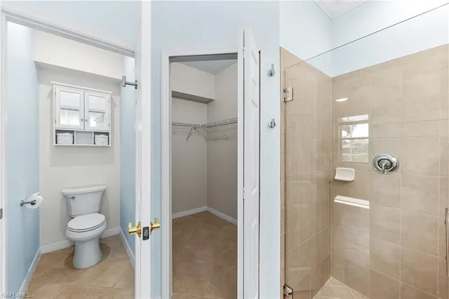 a bathroom with a toilet sink and shower