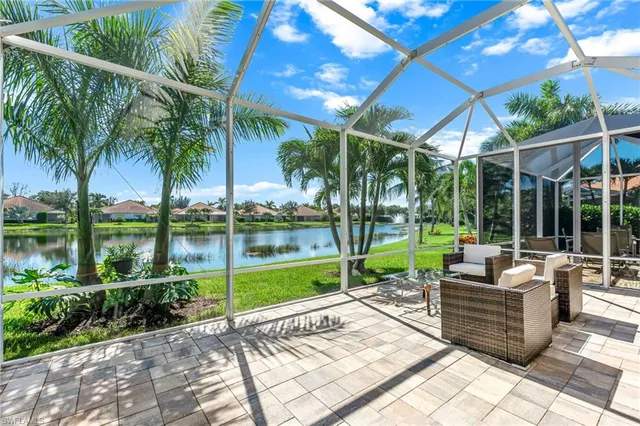 a view of a patio with couches and table and chairs under an umbrella