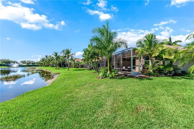 a view of a house with a yard and sitting area