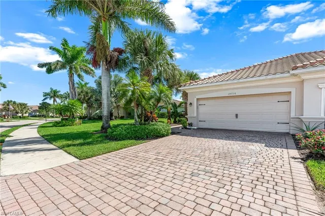 a front view of a house with a yard and a garage