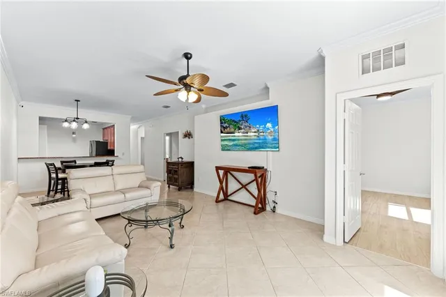a living room with furniture and kitchen view