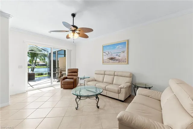 a living room with furniture and a ceiling fan