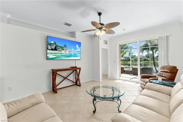 a living room with furniture a ceiling fan and a window