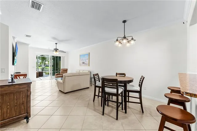 a dining room with furniture and a chandelier