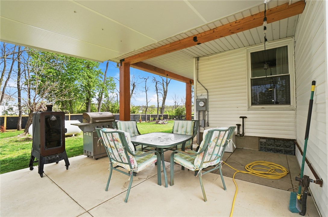 6155 North Union Road Clayton, OH 45315 - Photo 48 of 59 This inviting covered patio offers a comfortable outdoor space for relaxation and enjoyment.