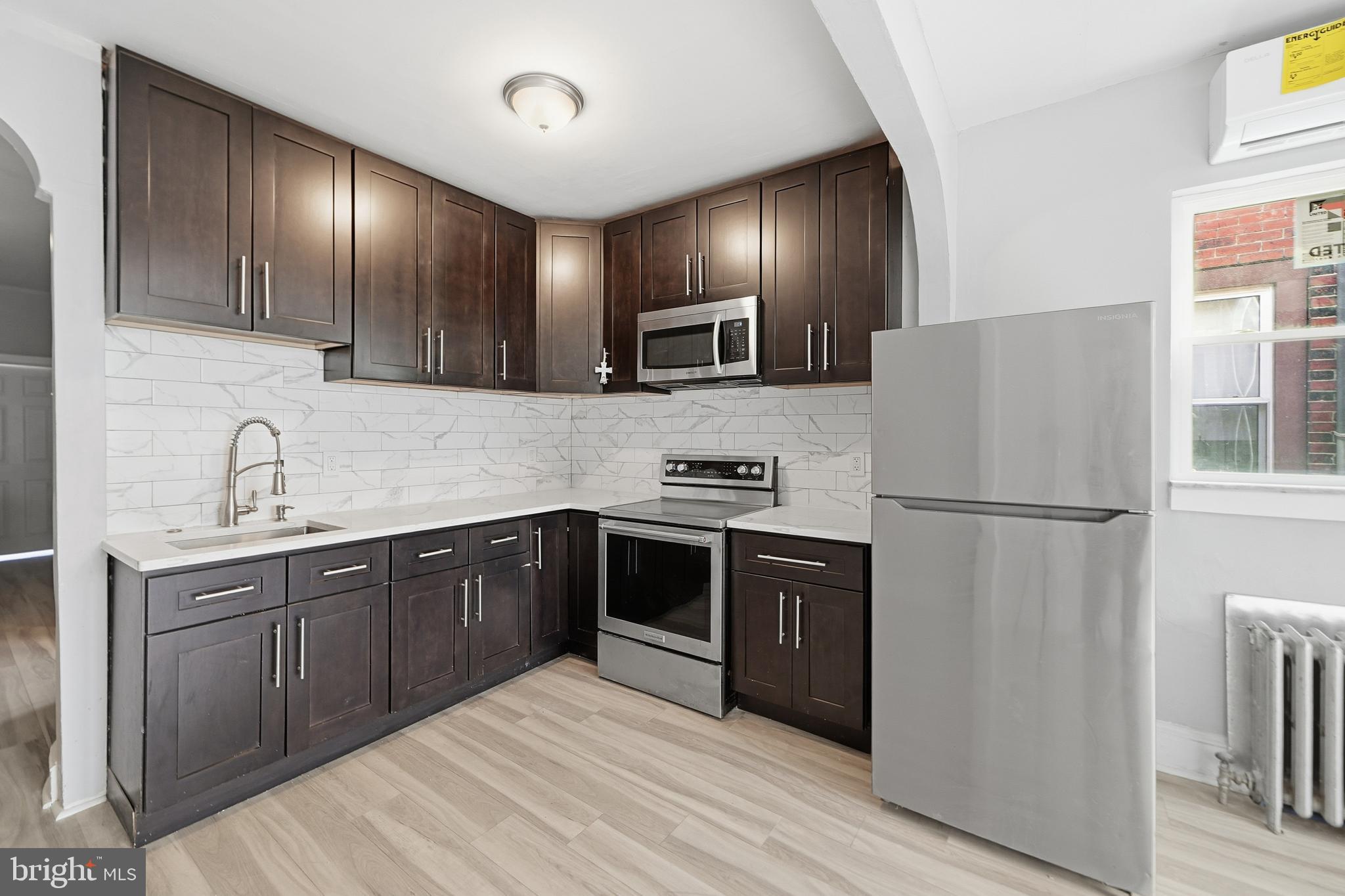 a kitchen with granite countertop stainless steel appliances and refrigerator