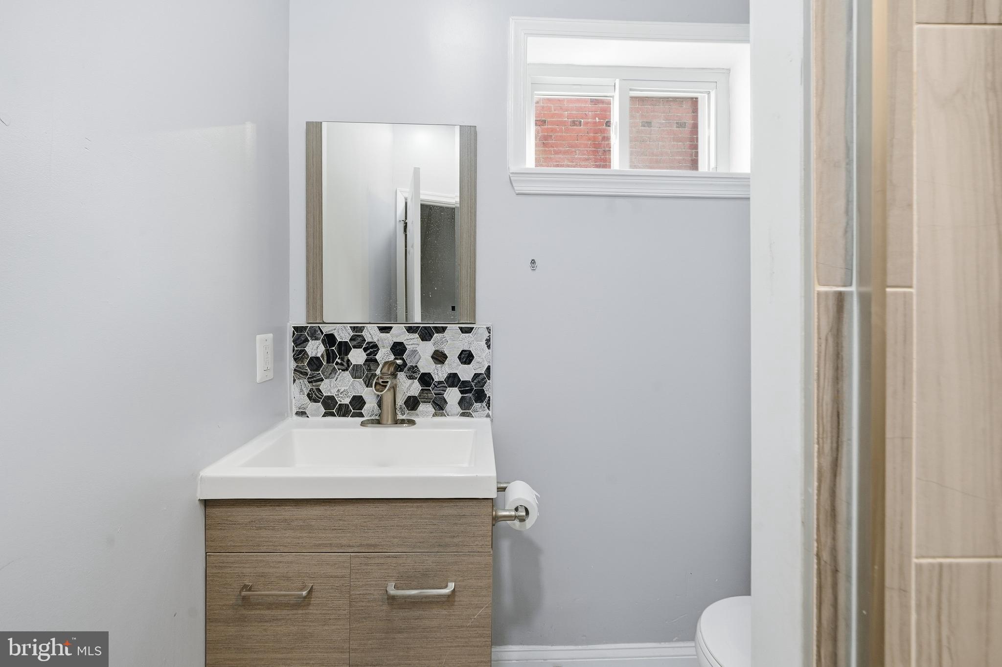1938 Mifflin Street Philadelphia, PA 19145 - Photo 5 of 11 a bathroom with a sink and a mirror