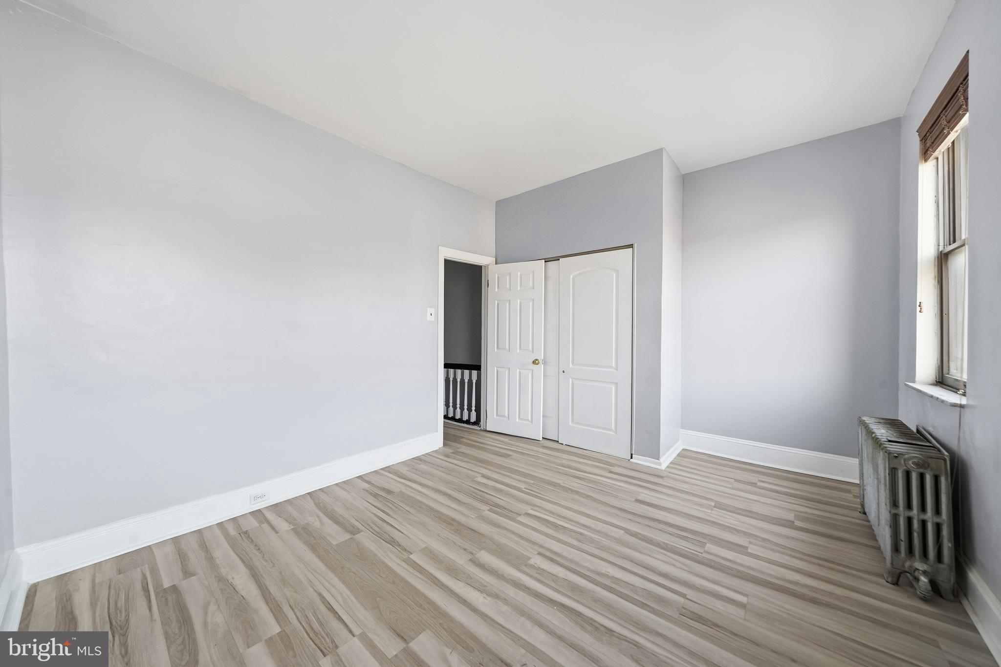 1938 Mifflin Street Philadelphia, PA 19145 - Photo 7 of 11 wooden floor in an empty room with a window