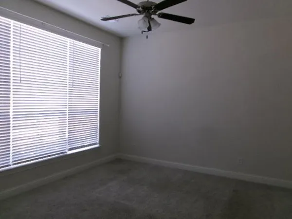 a view of a hallway with windows and stairs