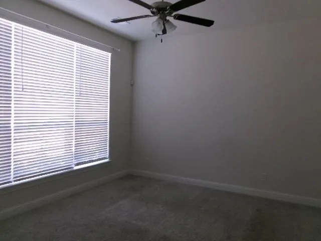 a view of a hallway with windows and stairs