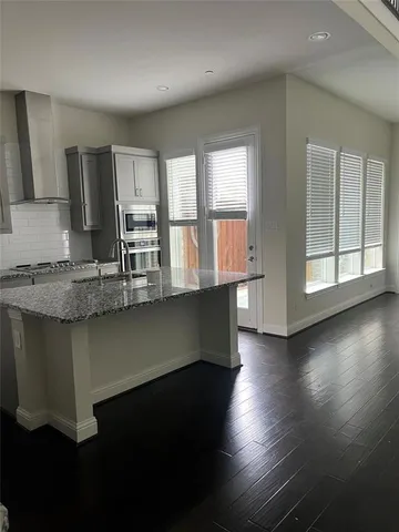 a kitchen with counter space and windows