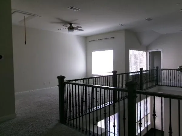 a view of a hallway with a window