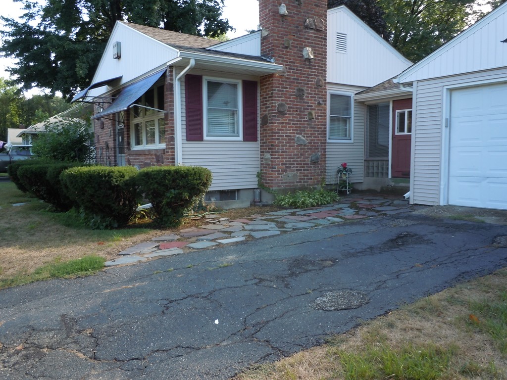 56 East Allen Ridge Road Springfield, MA 01118 - Photo 2 of 13 a front view of a house with a garden