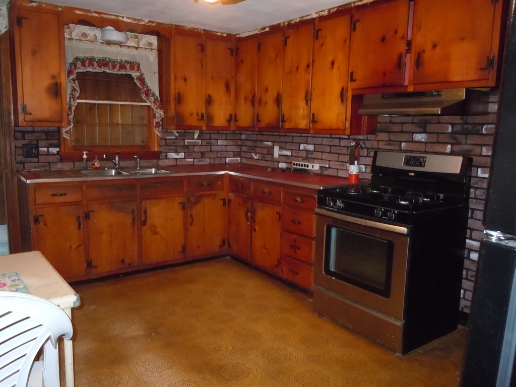 56 East Allen Ridge Road Springfield, MA 01118 - Photo 5 of 13 a kitchen with stainless steel appliances a stove and a microwave