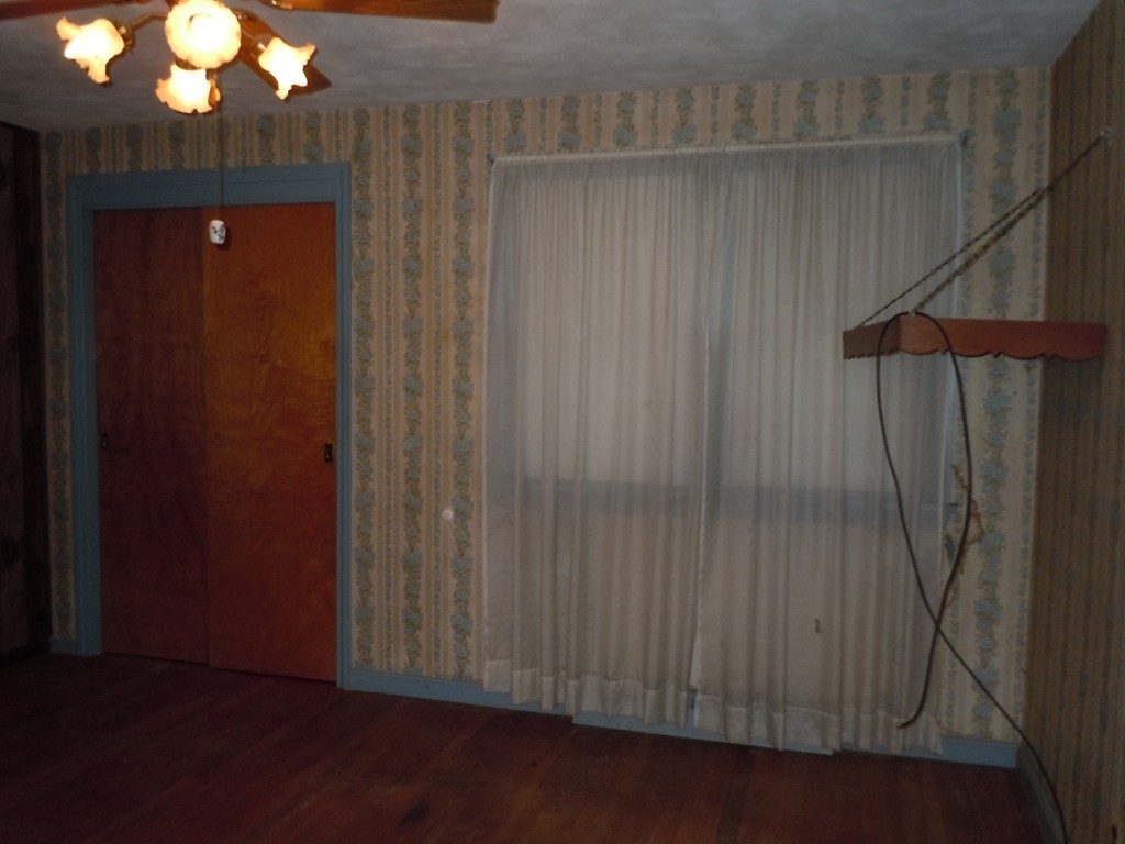 56 East Allen Ridge Road Springfield, MA 01118 - Photo 6 of 13 an empty room with wooden floor and fan